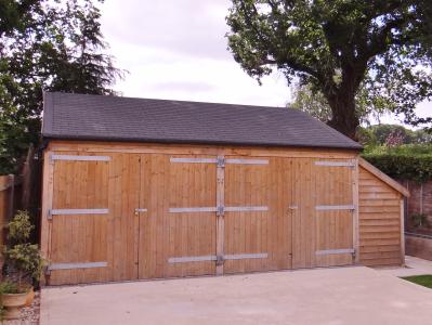 Pic 89. 6.0m x 5.4m Carriage House with barn doors and attached Log Store